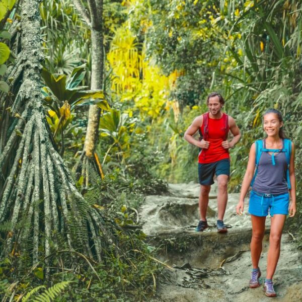 Man and woman hikers in Hawaii tropical jungle